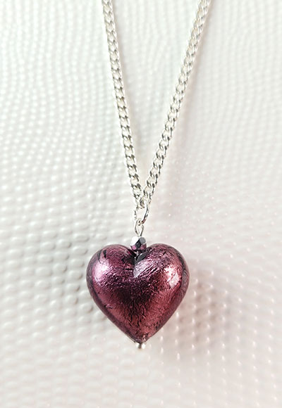 Magnifique pendentif coeur soufflé à la bouche et tapissé d'argent coloris violine sur chaine plaquée argent de 45cm environ. Ce collier est un cadeau d'amour à offrir ou à s'offrir. Ce bijou classique est une excellente idée cadeau pour toutes les femmes.